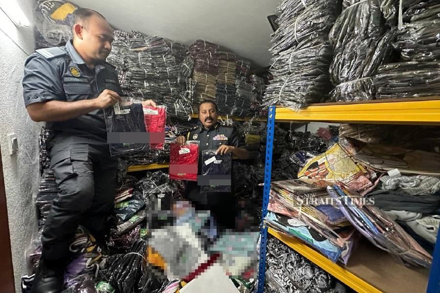 A man who managed to earn RM1,000 daily selling counterfeit branded clothes on social media was arrested in a raid today. - NSTP/ AMINAH YUSOF