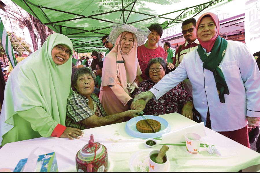 Pas's Seri Setia by-election candidate Dr Halimah Ali (centre) meets the people in Kelana Jaya. BERNAMA Photo.