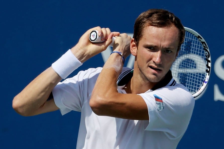  Daniil Medvedev of Russia plays a backhand during his match against Pablo Carreno Busta of Spain during Western & Southern Open - Day 6 at the Lindner Family Tennis Center on August 20, 2021 in Mason, Ohio. Dylan Buell/Getty Images/AFP