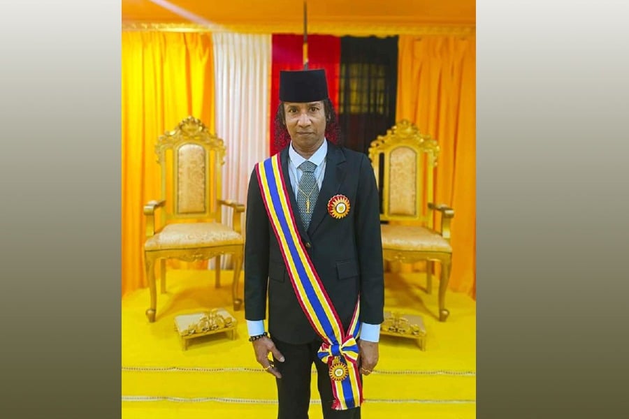 Musician Darkkey Nagaraja has courted controversy on social media after posting a picture of him dressed in a suit and sporting a sash similar to those worn during the conferment of royal awards. - Pic source from Social Media