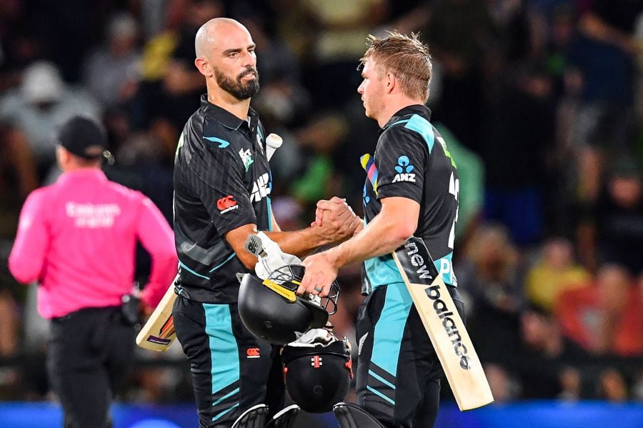 New Zealand's Daryl Mitchell (left) and New Zealand's Glenn Phillips congratulate each other at end of the fourth Twenty20 international cricket match between New Zealand and Pakistan at Hagley Oval in Christchurch. - AFP pic
