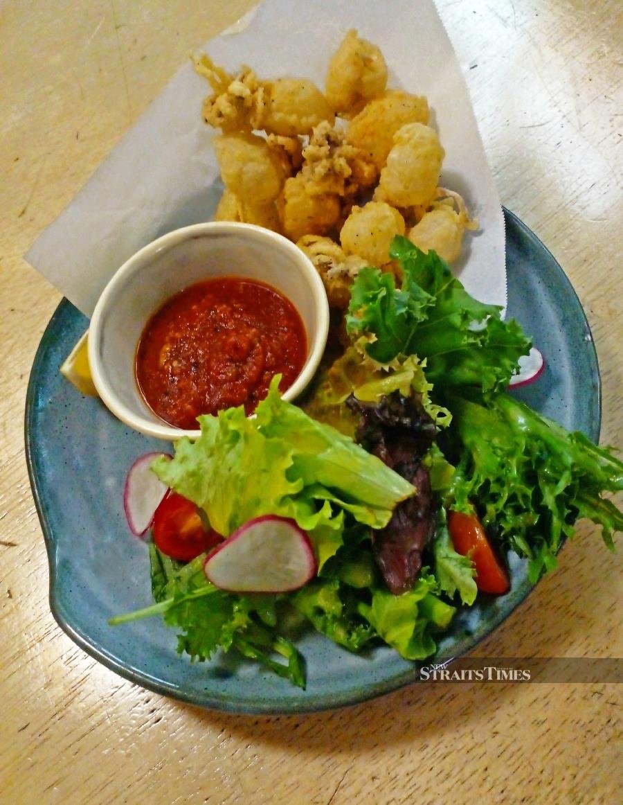 Deep fried baby cuttle fish with mesculan salad and arrabbita sauce.