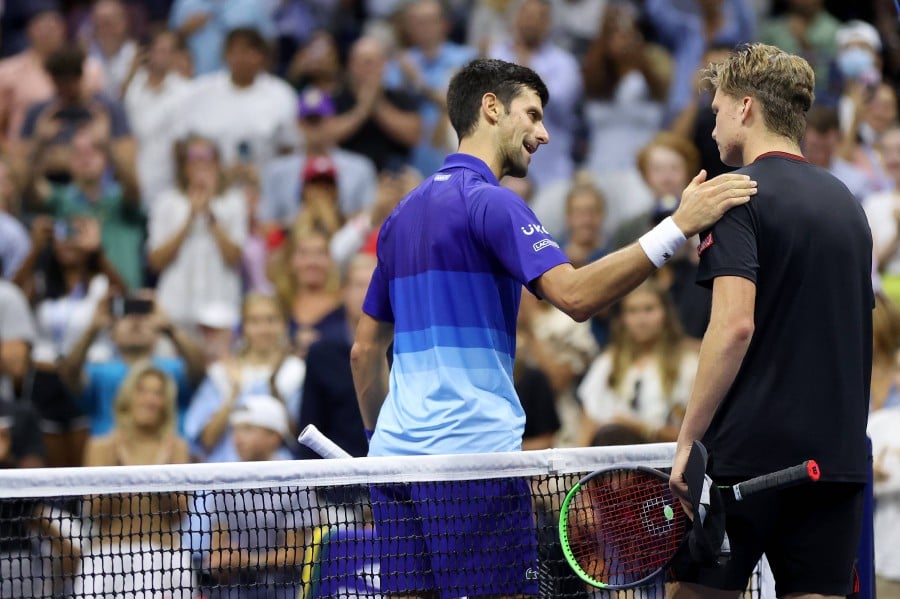  (L-R) Novak Djokovic of Serbia shakes hands with Jenson Brooksby of the United States at centre court after Djokovic won during their men’s singles round of 16 match on Day Eight of the 2021 US Open at USTA Billie Jean King National Tennis Center in the Flushing neighbourhood of the Queens borough of New York City. -AFP PIC