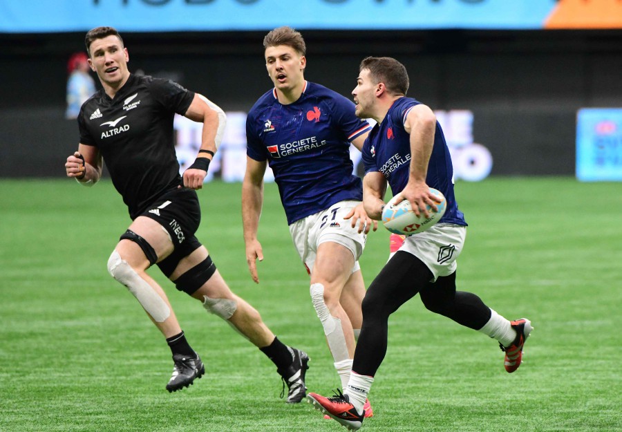 France's Antoine Dupont (R) passes the ball during the 2024 HSBC Canada Sevens rugby tournament match between France and New Zealand at BC Place Stadium in Vancouver, Canada. - AFP PIC