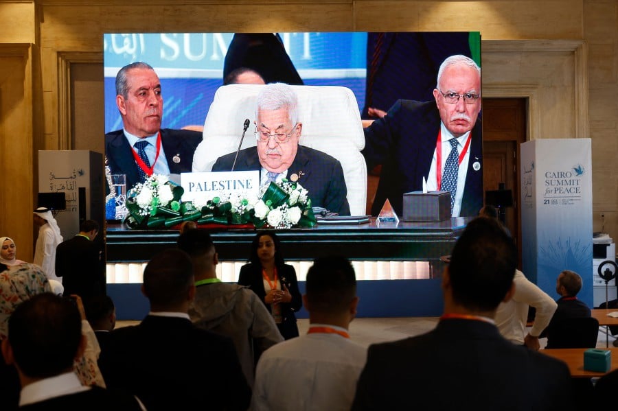 Seen on a large screen the Palestinian president Mahmud Abbas attends the International Peace Summit hosted by the Egyptian president in Cairo on October 21, 2023, amid the ongoing battles between Israel and the Palestinian group Hamas. AFP PIC