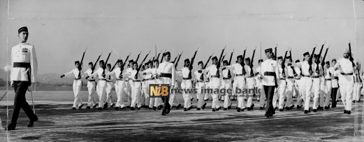 26 May 1959: Men of the new Royal Malayan Air Force marches past the saluting base led by the Officer in Charge of No.1 Squadron, Squadron Commander G. A. Charles at the full dress rehearsal for the King's first review of the RMAF in Kuala Lumpur.
