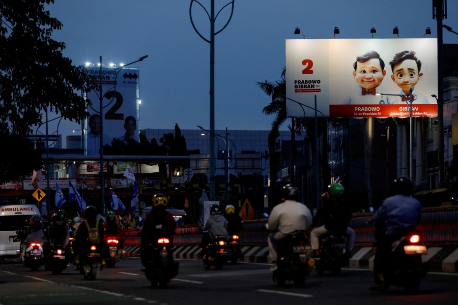 A billboard promoting Indonesia's Defence Minister and Presidential candidate Prabowo Subianto and his running mate Gibran Rakabuming Raka, who is the eldest son of Indonesian President Joko Widodo and current Surakarta's Mayor, is illuminated during the rush hour in Jakarta, Indonesia, January 12, 2024. REUTERS PIC