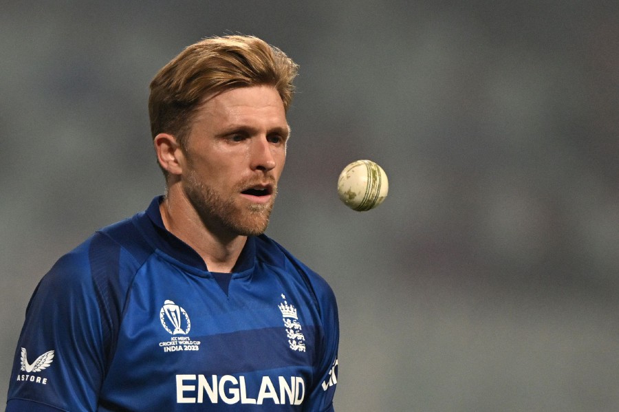 England's David Willey tosses the ball during the 2023 ICC Men's Cricket World Cup one-day international (ODI) match between England and Pakistan at the Eden Gardens in Kolkata. - AFP pic