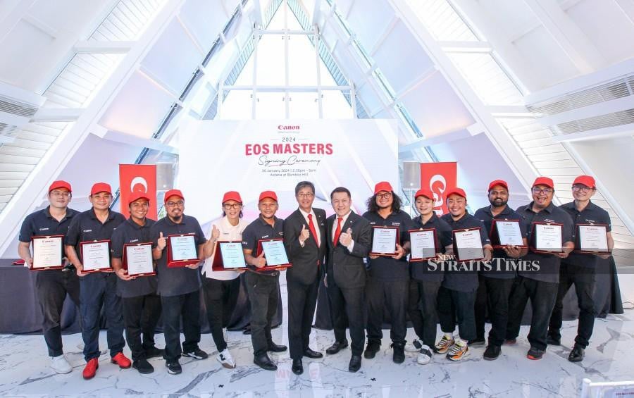 Canon Marketing Malaysia president, Masato Yoshiie (seventh from left) and Canon Marketing Malaysia head of Division, Image Communication Business, Edward Chang (seventh right), together with EOS Master during the EOS Masters signing ceremony 2024 at Astana, Bamboo Hills. STR/ AZIAH AZMEE