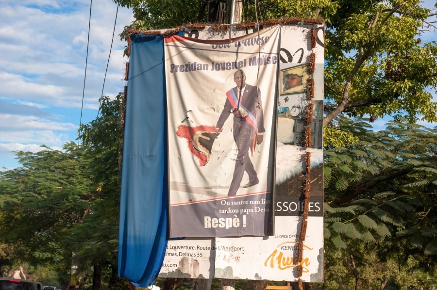 Photograph of a banner hanging in a street with the image of the assassinated President Jovenel Moise, in Petion-ville, Haiti. - EPA Pic