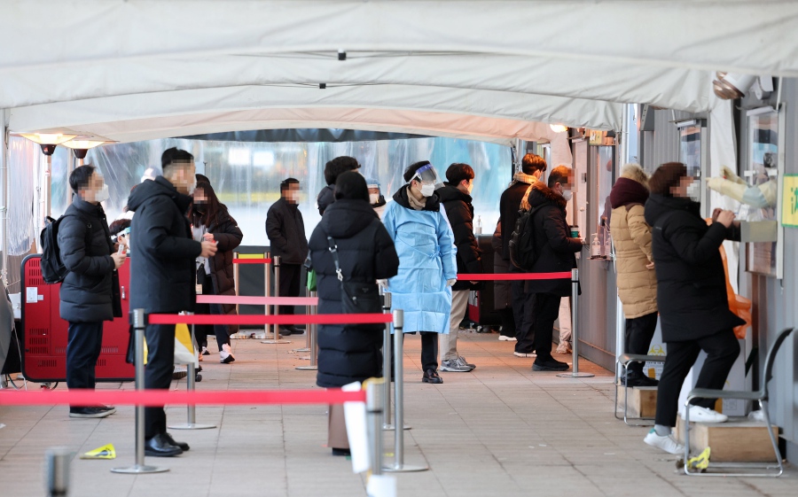 People stand in line to take coronavirus tests at a screening clinic in front of Seoul City Hall, Seoul, South Korea. -EPA Pic