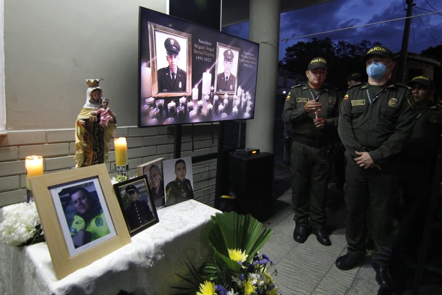 Relatives and friends of the murdered policemen, gathered at the door of the Metropolitan Police command to participate in a candlelight vigil as a protest against violence, and as a tribute to the 36 police officers killed so far this year in the country, in Cucuta, Colombia. - EPA Pic