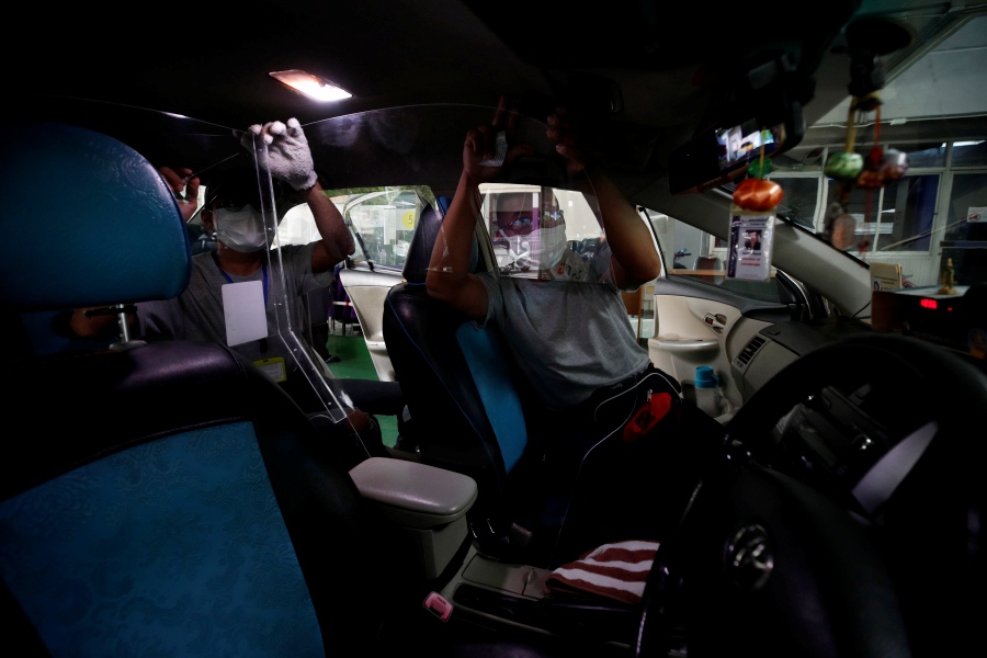 Workers install acrylic partition shields in taxis as part of the preparations to reopen the country at the Land Transport Department in Bangkok, Thailand, 14 October 2021. The Thai Ministry of Transport has announced the free installation of a special acrylic barrier on taxis to prevent the transmission of the COVID-19 pandemic in preparation for the country's reopening to tourists. From 01 November 2021, Thailand will reopen to fully vaccinated foreign tourists from at least 10 low-risk countries without quarantine requirements, boosting the tourism industry and economy. EPA pic