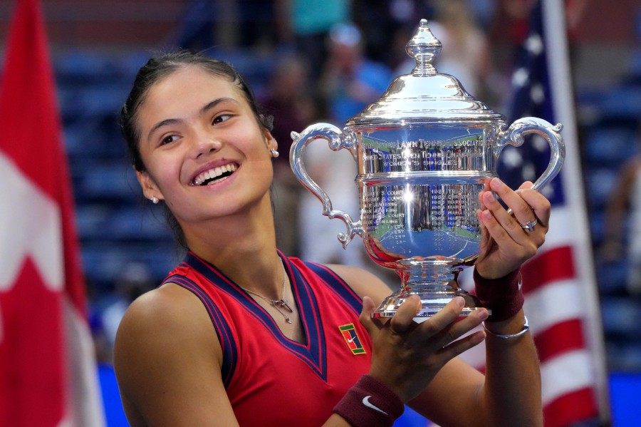 Britain's Emma Raducanu celebrates with the trophy after winning the 2021 US Open Tennis tournament women's final match against Canada's Leylah Fernandez at the USTA Billie Jean King National Tennis Center in New York, on September 11, 2021. - AFP pic