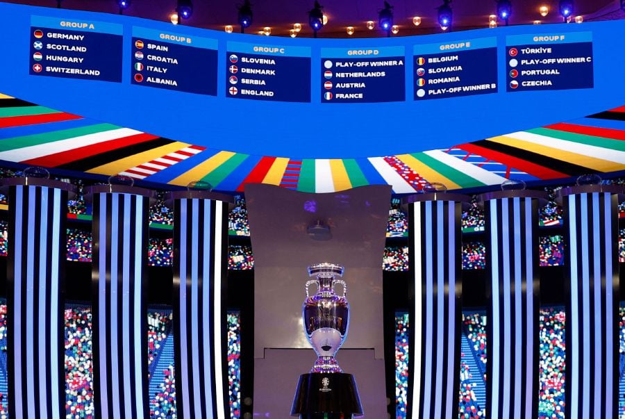 A general view shows the trophy in front of the drawn groups after the final draw for the UEFA Euro 2024 European Championship football competition in Hamburg, northern Germany. - AF pic