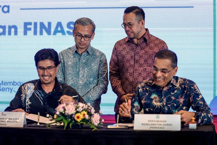 Communications Minister Fahmi Fadzil and Human Resources Minister Steven Sim witnessing the signing of a MoU between Finas and Perkeso, aimed at providing social security to film industry practitioners.