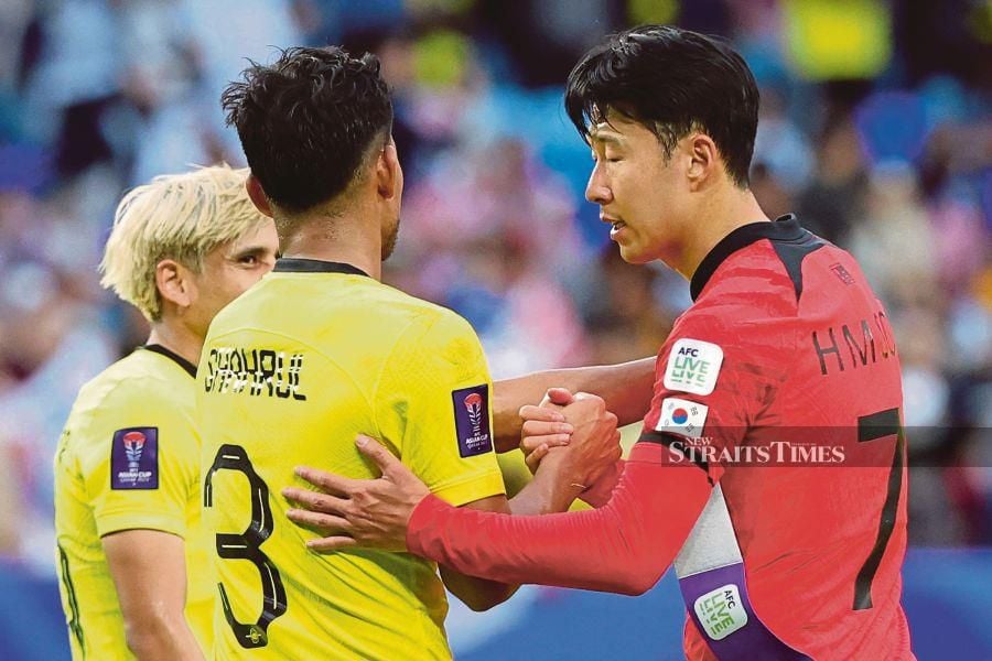 South Korea's Son Heung-min (right) gestures to Malaysia's Shahrul Saad at the end of their Asian Cup Group E match at Al-Janoub Stadium in al-Wakrah, south of Doha, on January 25. AFP PIC