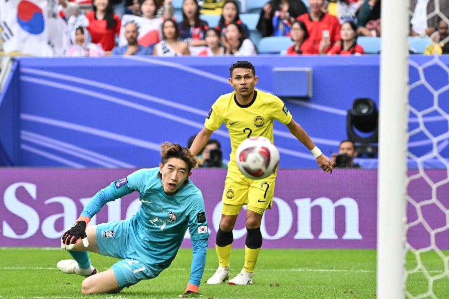 Malaysia's forward #07 Faisal Halim scores his team's first goal as South Korea's goalkeeper #21 Jo Hyeon-woo watches during the Qatar 2023 AFC Asian Cup Group E football match between South Korea and Malaysia at Al-Janoub Stadium in al-Wakrah, south of Doha, on January 25, 2024. AFP PIC