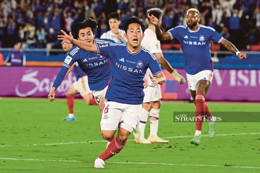 Yokohama's Kota Watanabe (centre) celebrates scoring during the Asian Champions League final first leg against Al Ain at Nissan Stadium, Kanagawa prefecture, Tokyo, on Saturday. AFP PIC 
