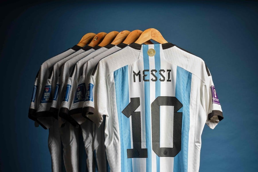 This undated photo courtesy of Sotheby's shows Lionel Messi's set of six match worn shirts from the 2022 FIFA World Cup. A set of six shirts worn by Lionel Messi during Argentina's victorious run to the 2022 World Cup in Qatar will be auctioned off in December, Sotheby's announced November 20, estimating their value at over 10 million. AFP PIC