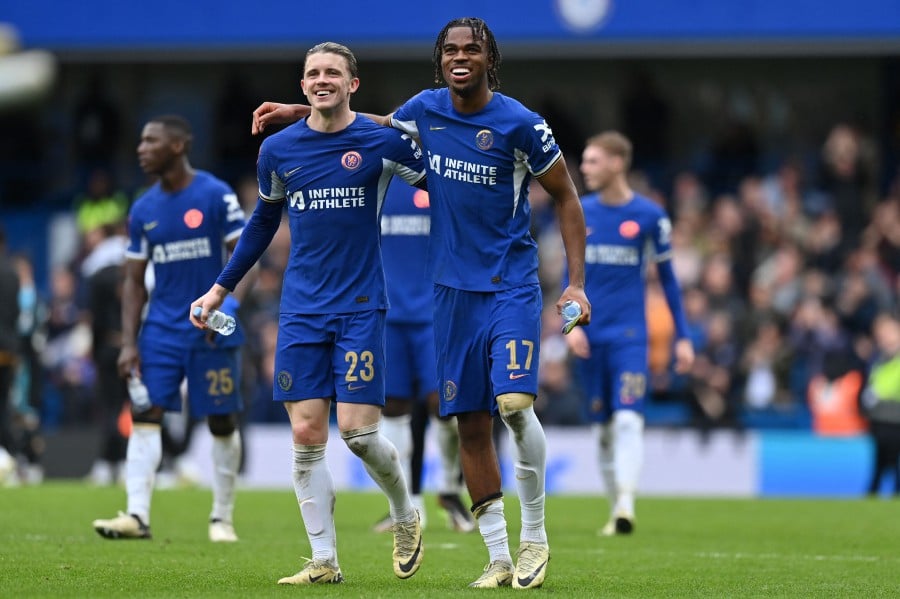 Chelsea's English midfielder #23 Conor Gallagher (L) and Chelsea's English midfielder #17 Carney Chukwuemeka (R) celebrate on the pitch after the English FA Cup Quarter Final football match between Chelsea and Leicester City at Stamford Bridge in London on March 17, 2024. Chelsea won the game 4-2. AFP PIC