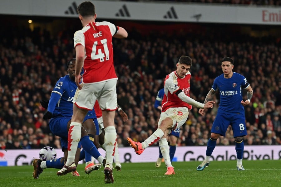 Arsenal's German midfielder #29 Kai Havertz (2R) shoots to score their fourth goal during the English Premier League football match between Arsenal and Chelsea at the Emirates Stadium in London on April 23, 2024. AFP PIC