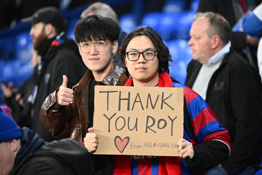 Palace fans hold up a message of support for their former manager Roy Hodgson ahead of the English Premier League football match between Everton and Crystal Palace at Goodison Park in Liverpool, north west England. (Photo by Paul ELLIS / AFP)