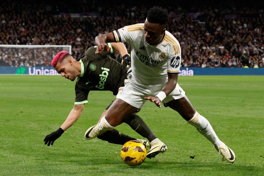 Real Madrid's Brazilian forward Vinicius Junior (R) fights for the ball with Girona's Brazilian defender Yan Couto during the Spanish league football match between Real Madrid CF and Girona FC at the Santiago Bernabeu stadium in Madrid. - AFP pic