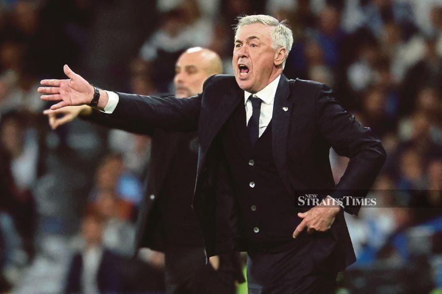 Real Madrid's Carlo Ancelotti shouts instructions to his players from the touchline during the Champions League quarter-final, first-leg match against Manchester City at the Santiago Bernabeu Stadium in Madrid on Tuesday. AFP PIC 