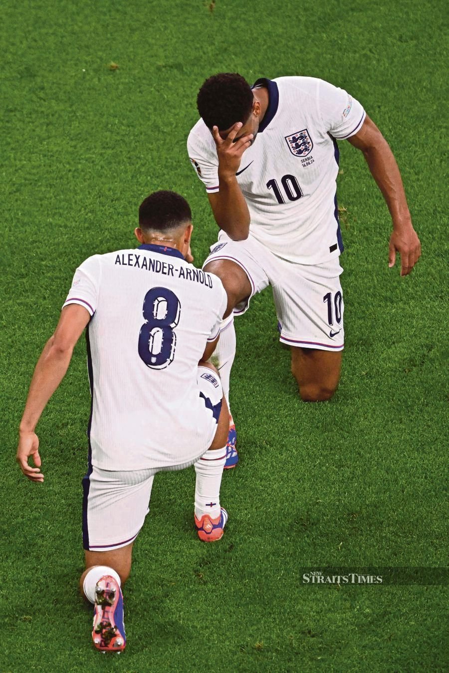 England Jude Bellingham celebrates with defender Trent Alexander-Arnold after scoring his team's first goal during the Euro 2024 Group C match against Serbia at the Arena AufSchalke in Gelsenkirchen on June 16, 2024. AFP PIC 