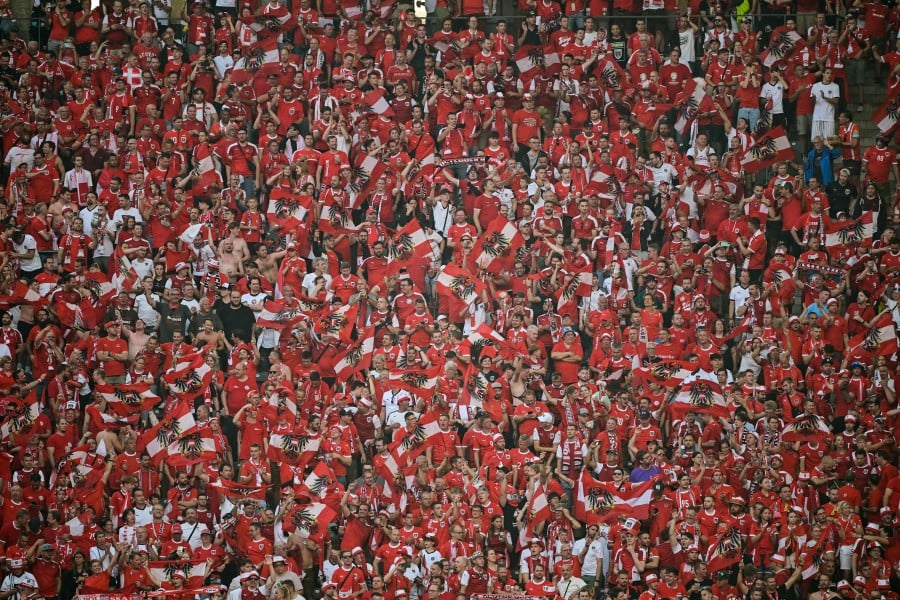 Austria supporters celebrate at the end of the UEFA Euro 2024 Group D football match between Poland and Austria at the Olympiastadion in Berlin on June 21, 2024. AFP PIC