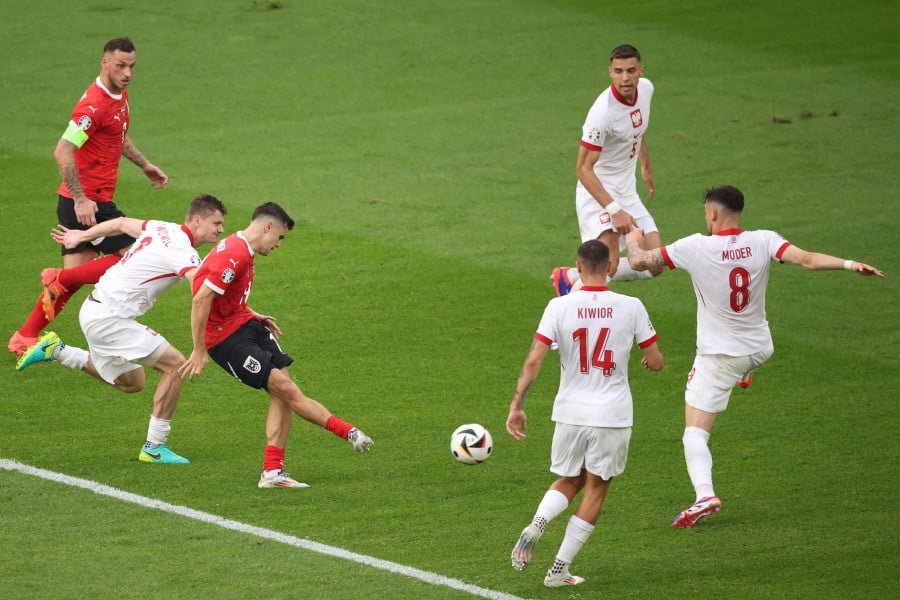 Austria's midfielder #19 Christoph Baumgartner shoots to score his team's second goal during the UEFA Euro 2024 Group D football match between Poland and Austria at the Olympiastadion in Berlin on June 21, 2024. AFP PIC