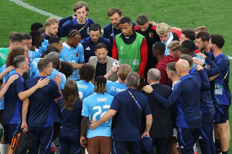 Belgium's head coach Domenico Tedesco (C) speaks to his players after the UEFA Euro 2024 Group E football match between Ukraine and Belgium at the Stuttgart Arena in Stuttgart on June 26, 2024. AFP PIC