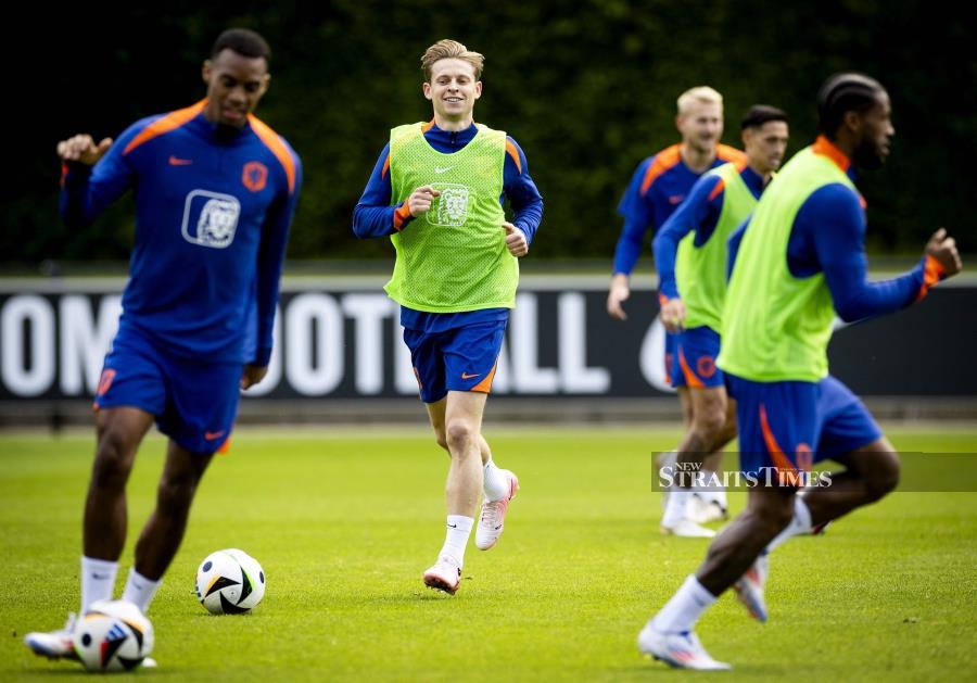 Netherlands' Ryan Gravenberch (left) and Frenkie de Jong (centre) take part in a training session as part of their preparations for Euro 2024 in Zeist on Sunday. AFP PIC 