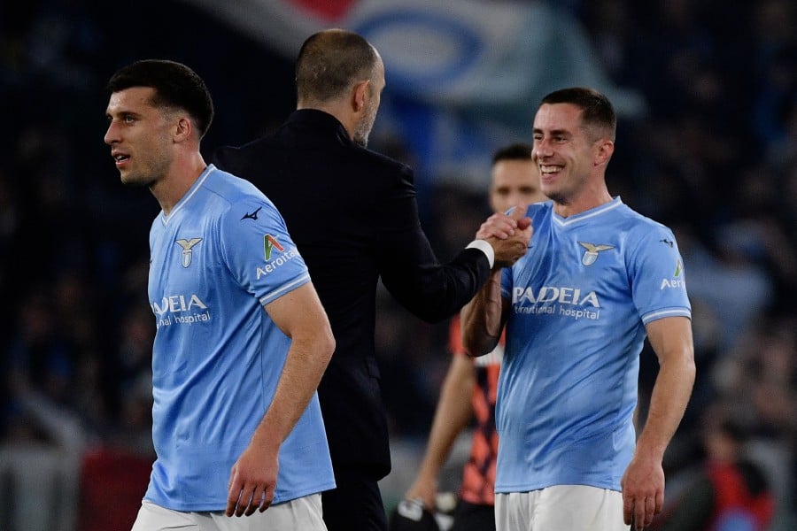 Lazio's Montenegrin defender #77 Adam Marusic is congratulated by Lazio's Croatian headcoach Igor Tudor at the end of the Italian Serie A football match between Lazio and Juventus at the Olympic stadium in Rome, on March 30, 2024. AFP PIC