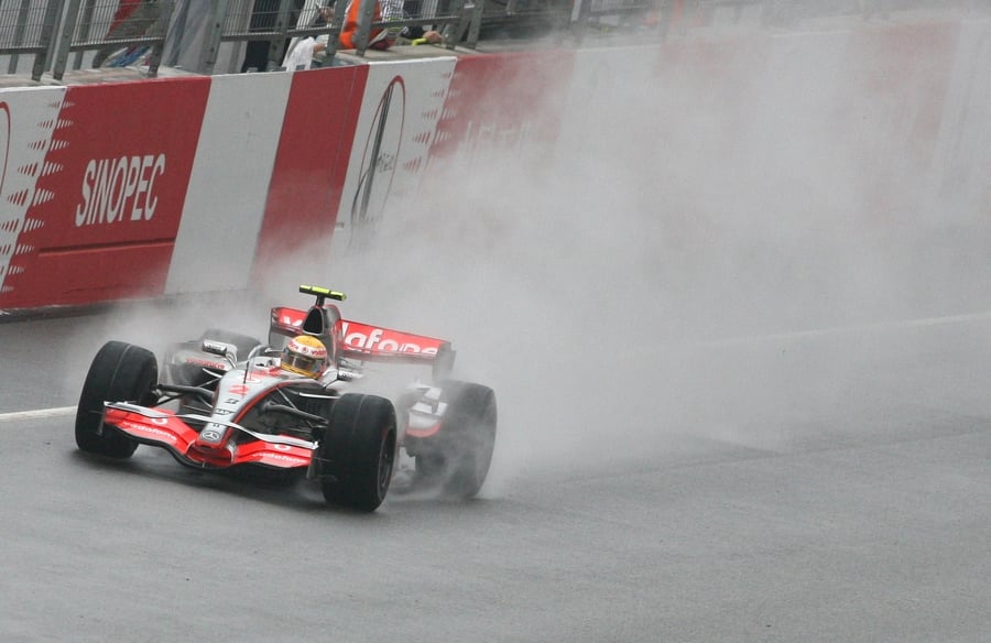 (FILES) British Formula One driver Lewis Hamilton from the McLaren Mercedes team drives in wet conditions on the main straight before crashing out of the Chinese Grand Prix at the Shanghai International Circuit in 2007. (Photo by MARK RALSTON / AFP)