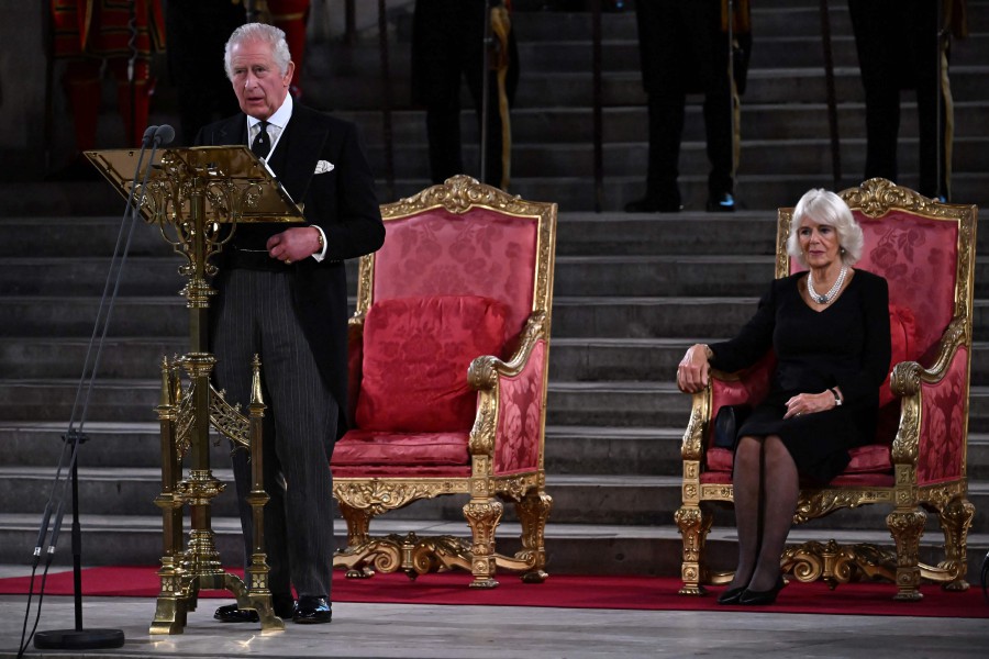 Britain's King Charles III, flanked by Britain's Camilla, Queen Consort, speaks during the presentation of Addresses by both Houses of Parliament in Westminster Hall, inside the Palace of Westminster, central London, following the death of Queen Elizabeth II on September 8. -AFP file pic