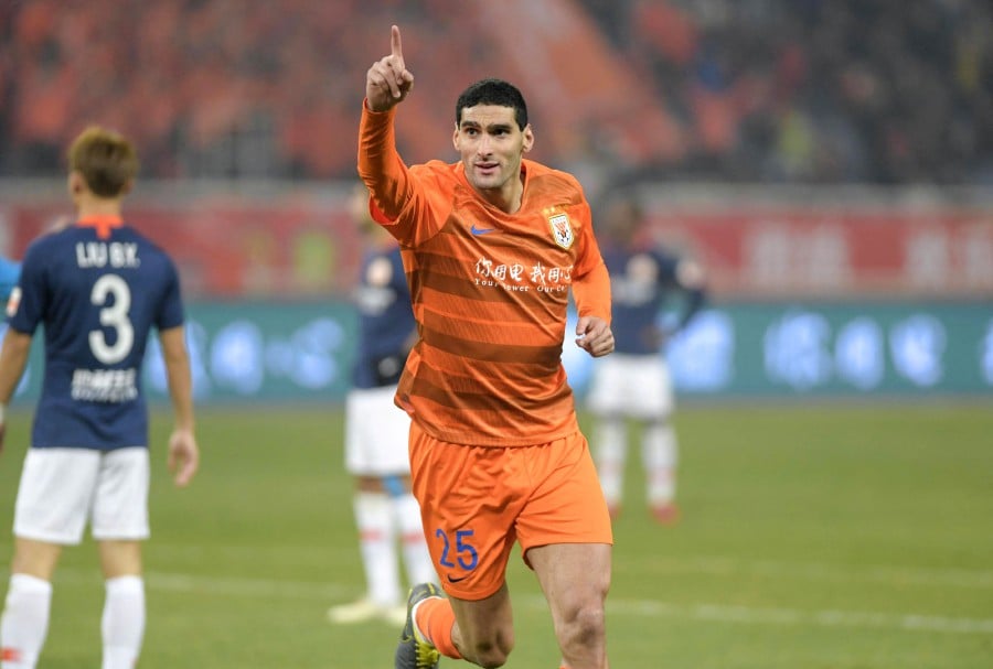 Shandong Luneng's Marouane Fellaini celebrates scoring a goal during the Chinese Super League (CSL) football match between Shandong Luneng and Beijing Renhe in Jinan in China's eastern Shandong province on March 1, 2019. Former Manchester United star Marouane Fellaini called his five years at Shandong Taishan "among the best of my life" as he bid an emotional farewell to China. AFP FILE PIC