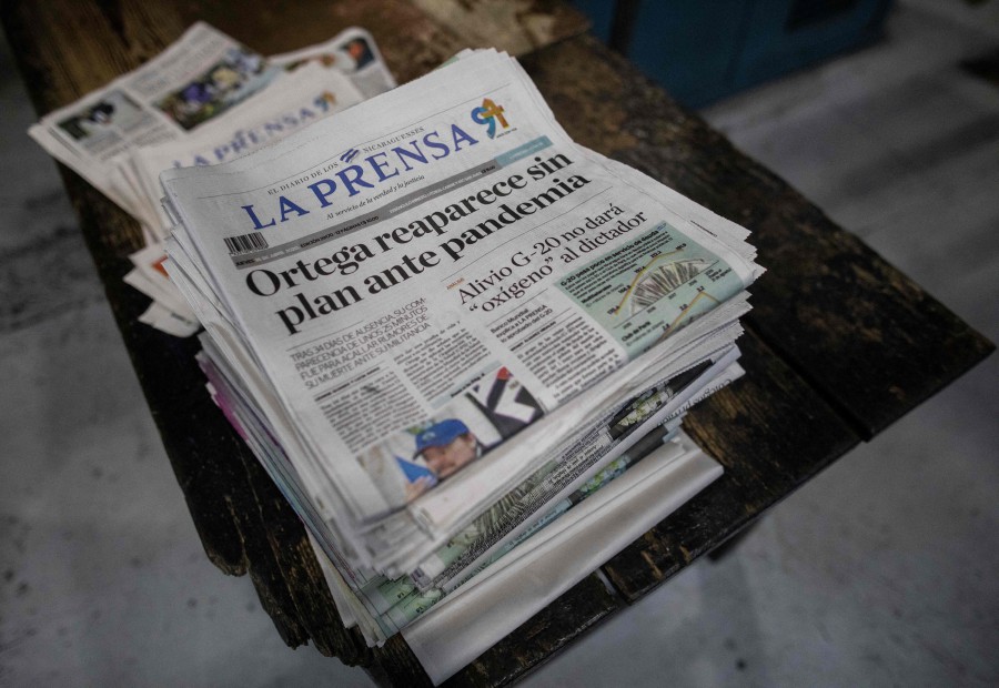 (FILES) In this file photo taken on April 16, 2020, view of local La Prensa newspapers in Managua, printed late on April 15, 2020, after Nicaraguan President Daniel Ortega spoke of the coronavirus pandemic and announced there would be no quarantine or cessation of economic activity. - Police in Nicaragua on August 13, 2021 raided the premises of independent newspaper La Prensa, which had branded the government a "dictatorship" after being forced to suspend its print edition. (Photo by INTI OCON / AFP)