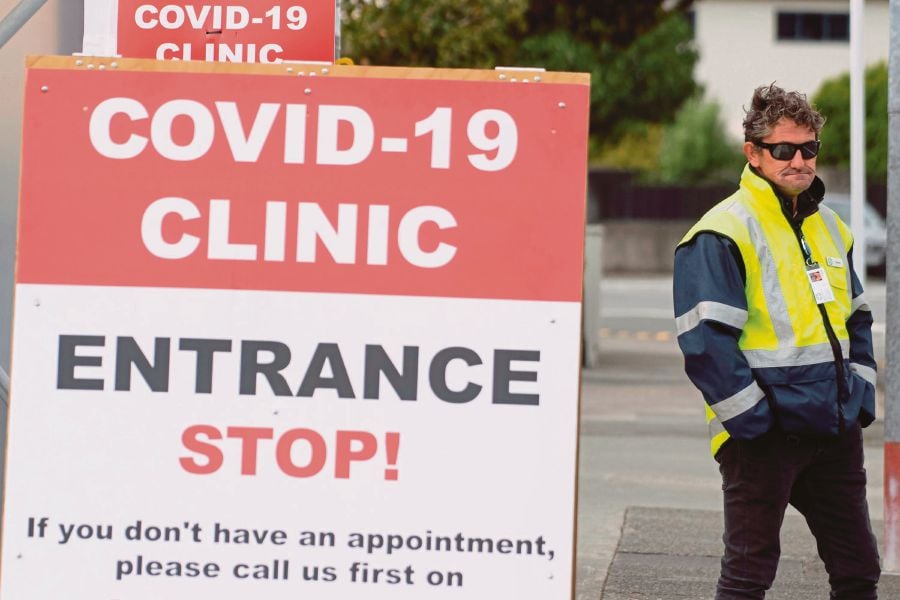 This file photo taken on April 20, 2020 shows a security guard standing outside a COVID-19 coronavirus clinic in Lower Hutt, near Wellington. -AFP pic