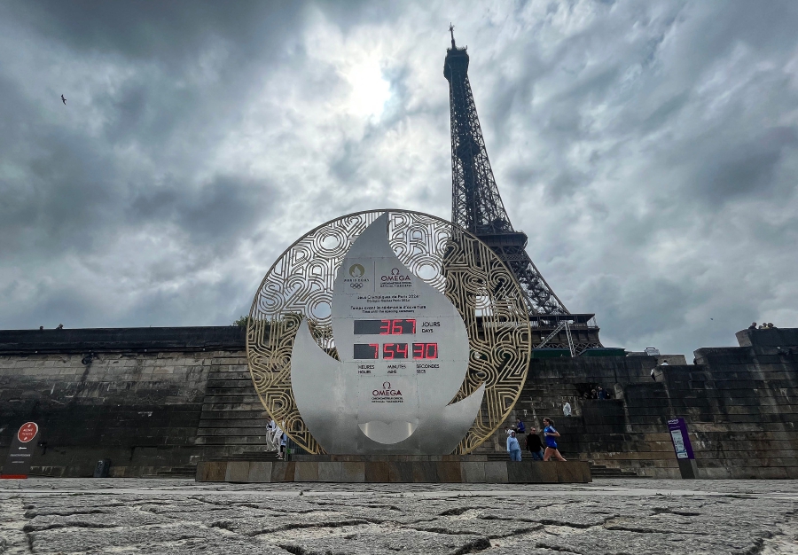(FILES) A photo shows a board displaying the countdown to the start of the Paris 2024 Olympic Games in front of the Eiffel Tower in Paris, on July 25, 2023. - AFP pic