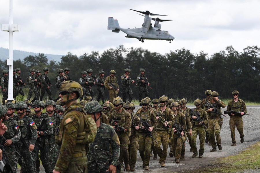 Philippine and Australian soldiers march in formation while a US marines V-22 Osprey hovers above during military exercise Alon (wave), a joint amphibious landing drill held at a naval base in San Antonio town in Zambales province, north of Manila on August 25, 2023. The Philippines will hold joint naval drills with the United States, Japan and Australia, two diplomatic sources told AFP on April 4, 2024, as the four countries deepen military ties to counter China's expanding influence in the Asia-Pacific region. AFP FILE PIC