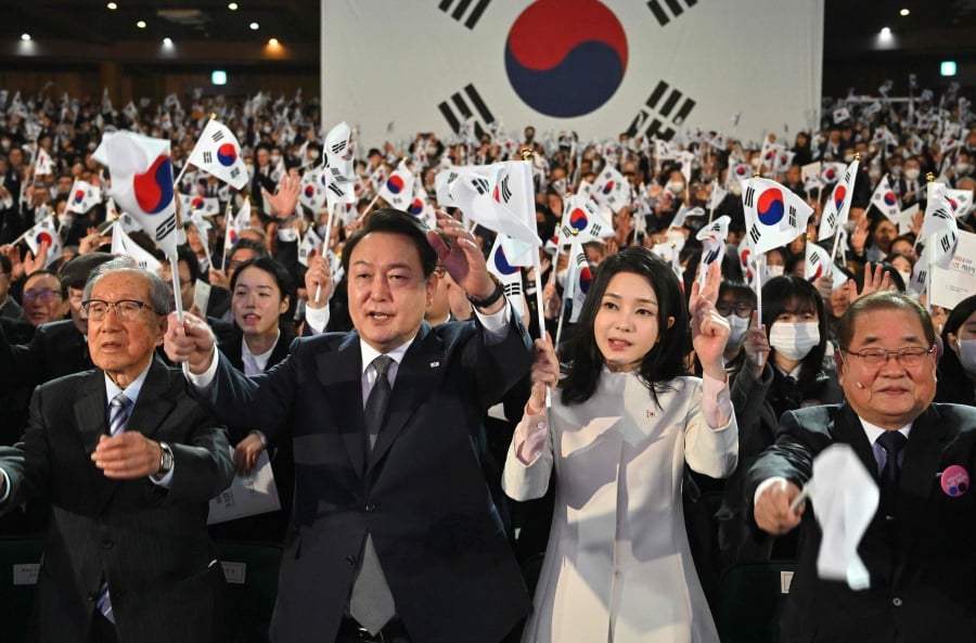 (FILES) South Korea's President Yoon Suk Yeol (second from left) and his wife Kim Keon Hee (second from right) give three cheers during a ceremony marking the 104th anniversary of the March 1st Independence Movement Day against Japanese colonial rule, in Seoul. (Photo by JUNG YEON-JE / POOL / AFP)