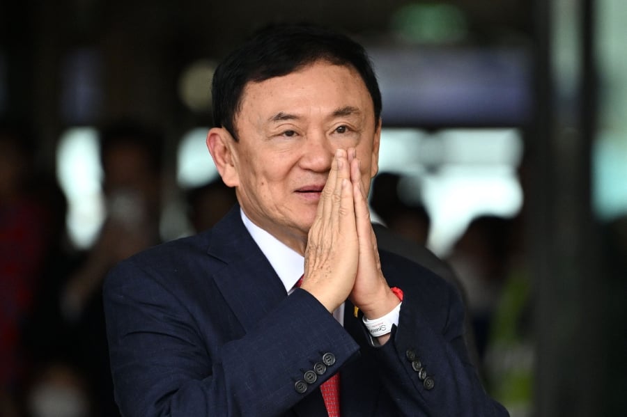 (FILES) Former Thai Prime Minister Thaksin Shinawatra greets his supporters after landing at Bangkok's Don Mueang airport on August 22, 2023.- AFP pic