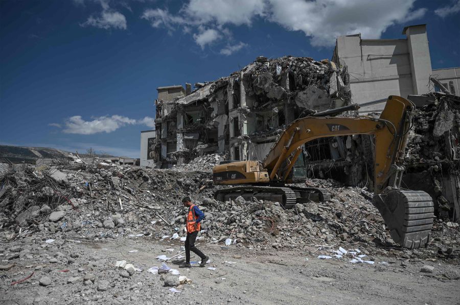 An excavator removes the rubbles of collapsed buildings in the quake-hit city of Kahramanmaras on April 4, 2023, two months after the 7.8 magnitude devastating earthquake of February 6. -  AFP Pic