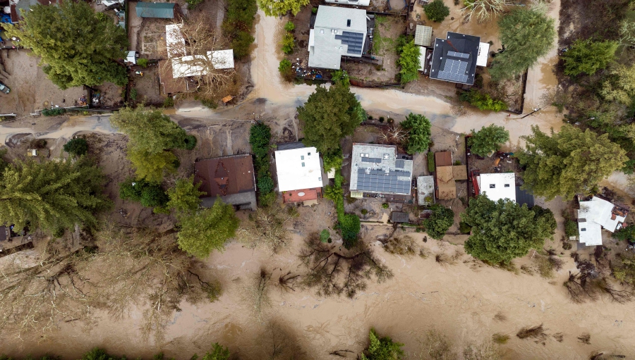 (FILES)An aerial view of flooded homes in Felton, California. (Photo by JOSH EDELSON / AFP)