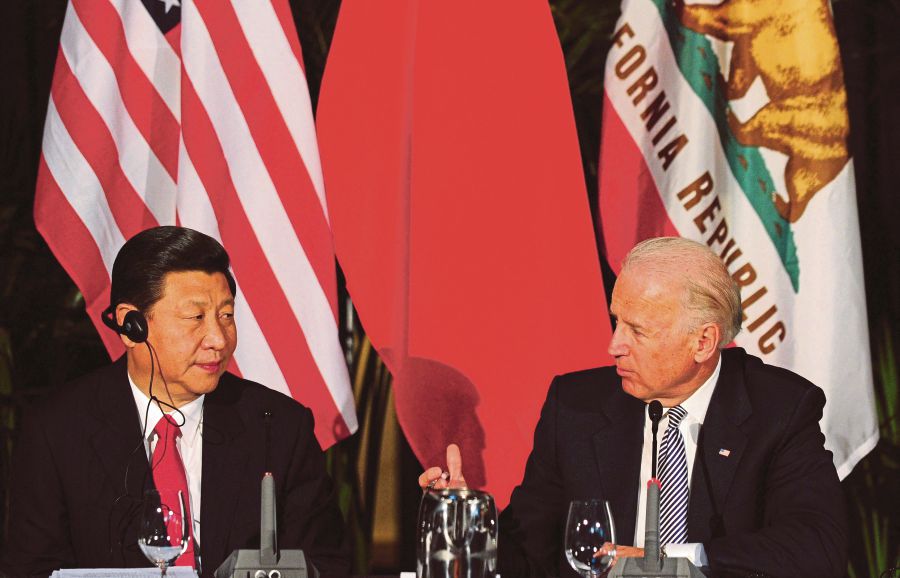 (FILES) US President Joe Biden (right) speaks as his visiting Chinese counterpart Xi Jingping (left) looks on during a meeting of governors in Los Angeles, California in 2012. (Photo by Frederic J. BROWN / AFP)