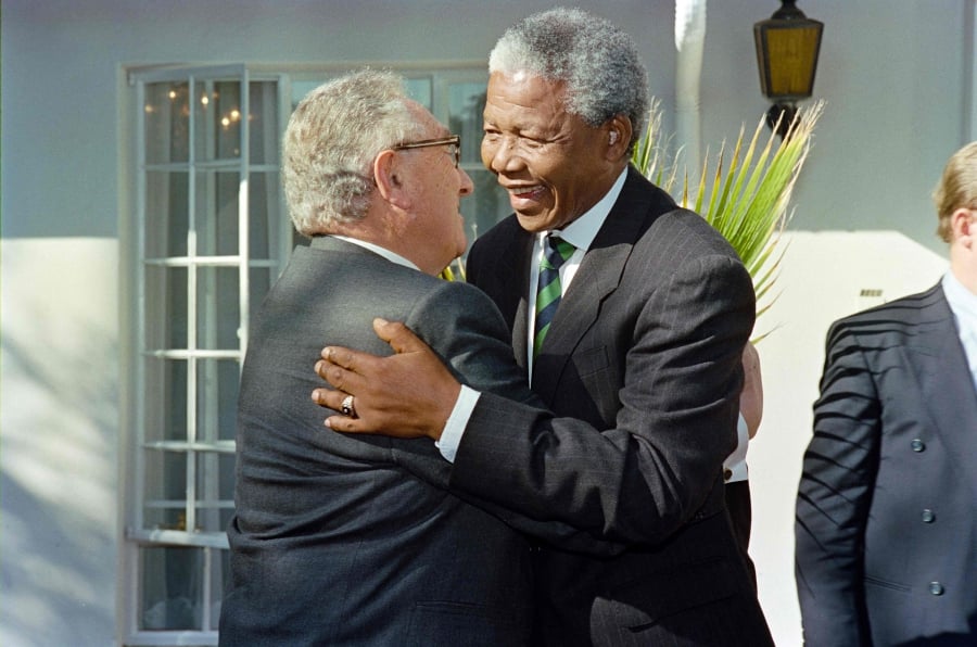 (FILES) African National Congress President Nelson Mandela (right) gives former US Secretary of State Henry Kissinger (left) a welcome hug upon his arrival for their meeting in Johannesburg. (Photo by Walter DHLADHLA / AFP)