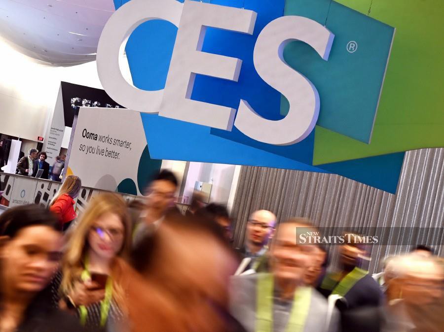 Attendees walk through the hall at the Sands Expo Convention Center during CES 2019 show in Las Vegas, Nevada.