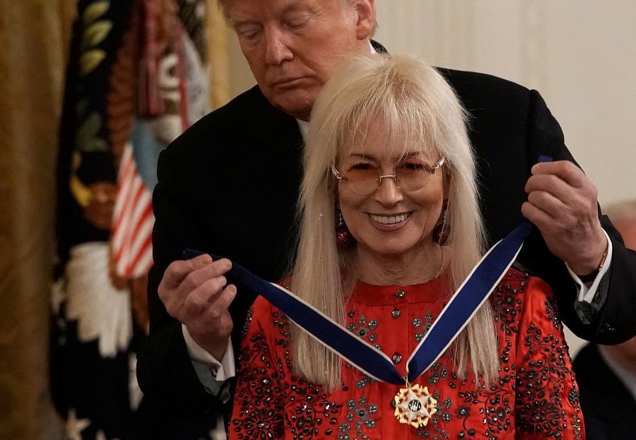 US President Donald Trump presents the Presidential Medal of Freedom to physician Miriam Adelson, wife of Sheldon Adelson, during an East Room ceremony November 16, 2018 in Washington, DC. In an electoral system in which money is the ultimate kingmaker, Trump has been courting the country's billionaires -- and they have their checkbooks ready. AFP